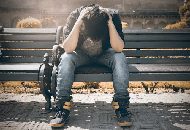 sad man on a bench victim of ghosting